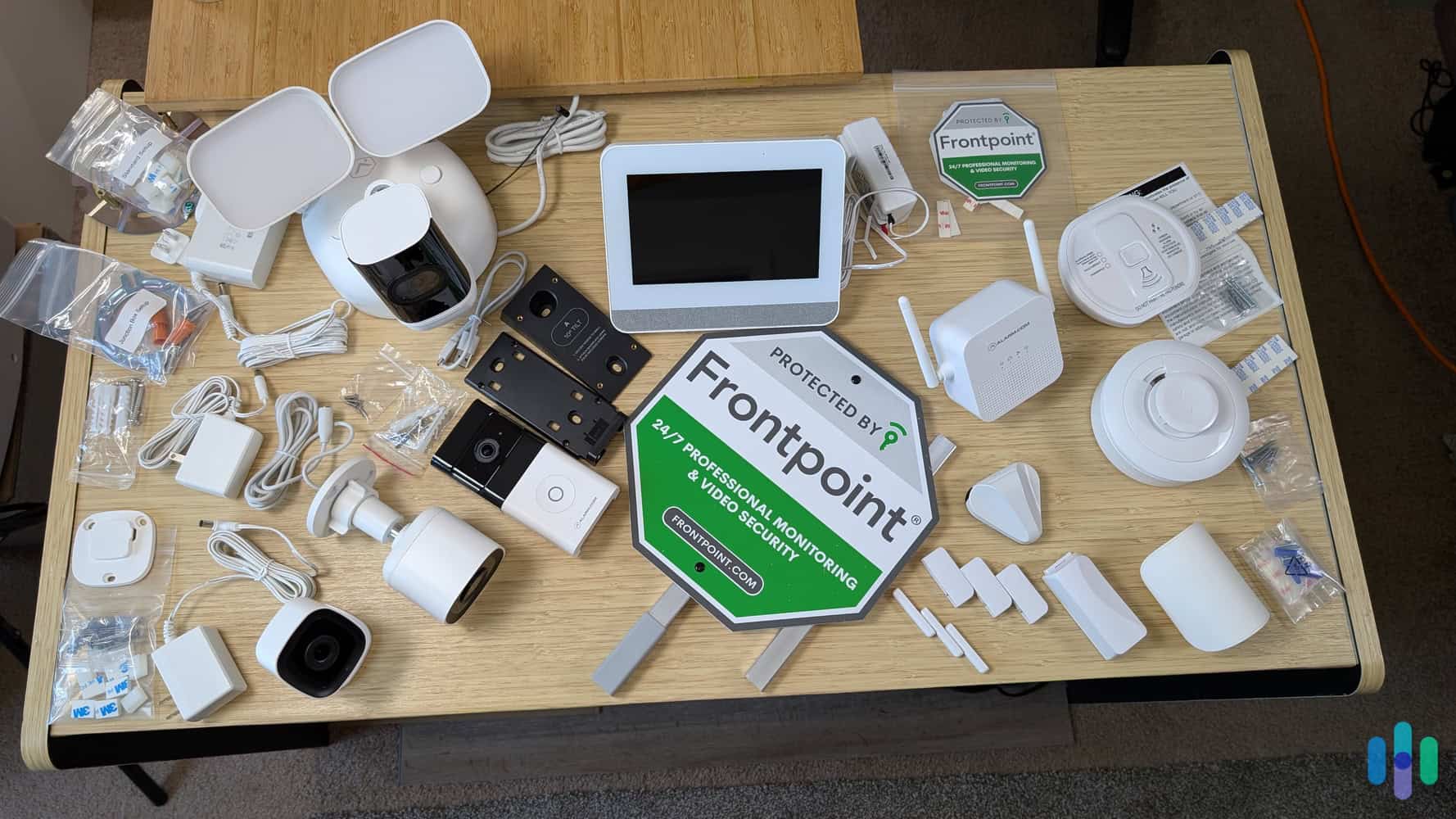 Frontpoint-equipment-and-installation-materials-on-desk (1) Frontpoint security systems include all the mounting hardware and power cables you'll need for installation